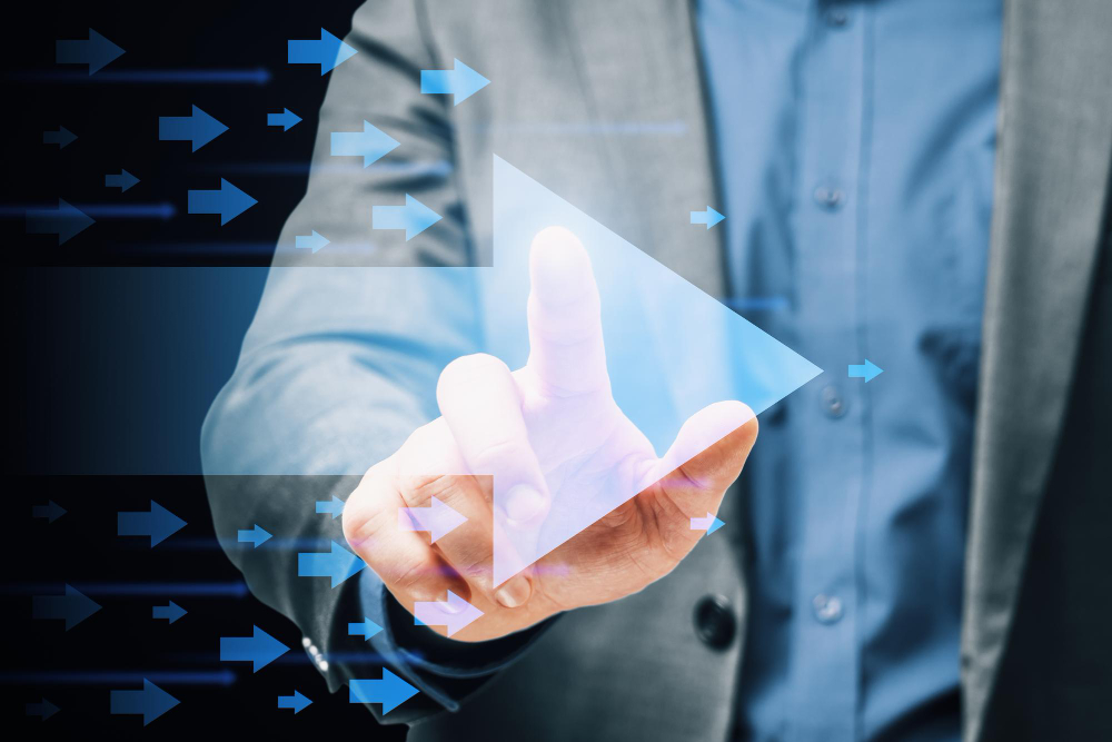 Businessman touching play button with arrows